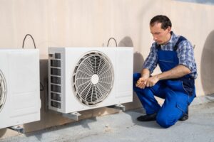 technician performing heat pump maintenance