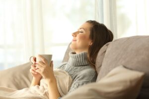 woman enjoying improved IAQ with air cleaner